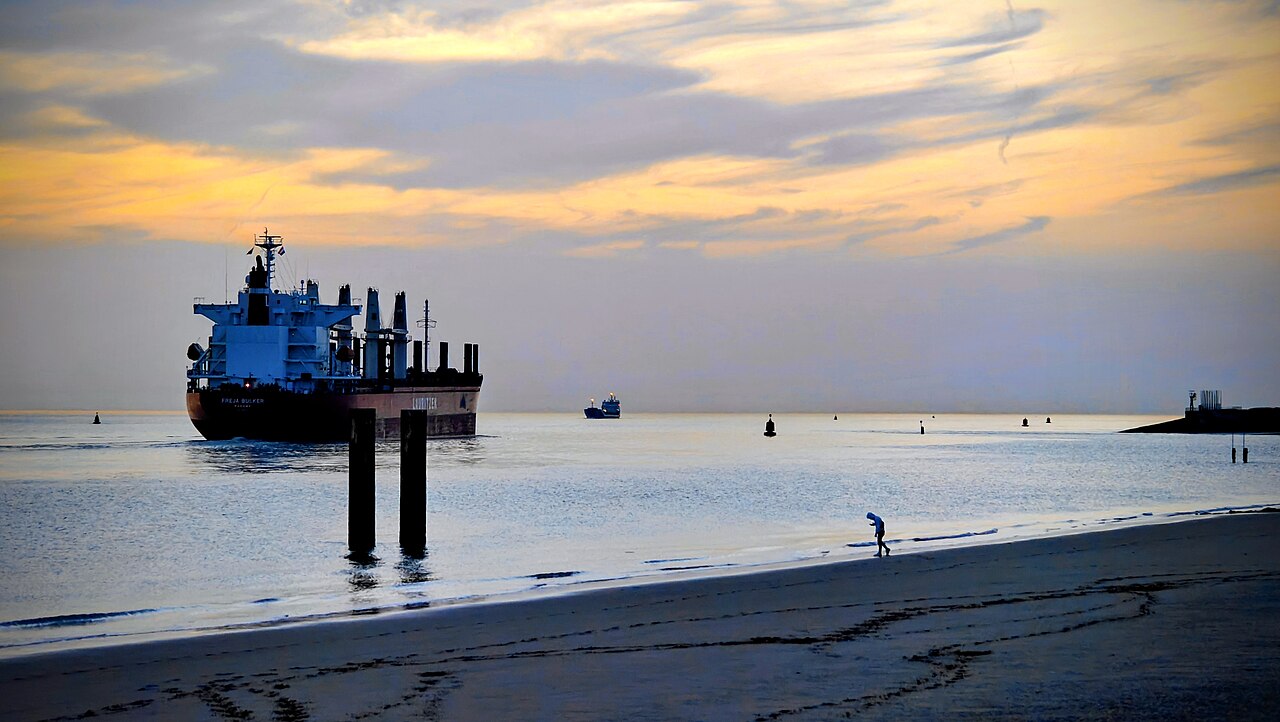 Cargo ship at dusk — maritime compliance solutions by Varuna Sentinels BV